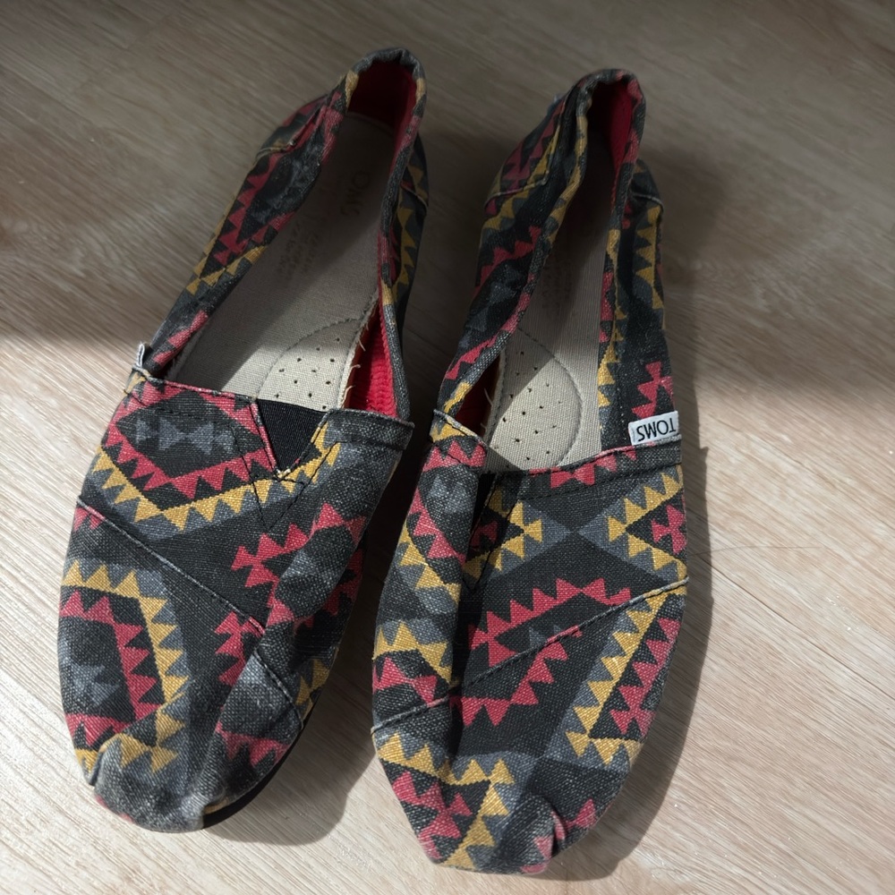 Toms Black Canvas Slip-Ons with Red & Mustard Geometric Print